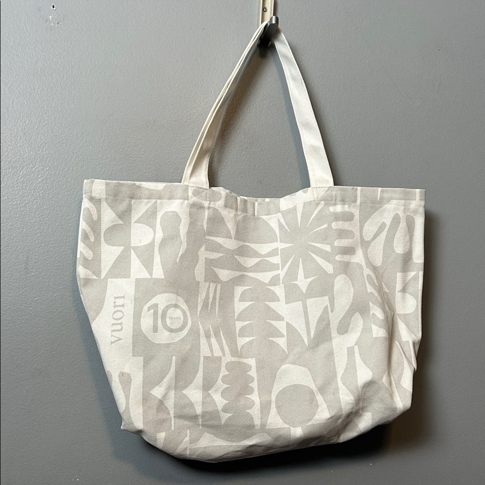 Vuori Limited Edition 10-Year Anniversary tote bag in grey and white canvas.